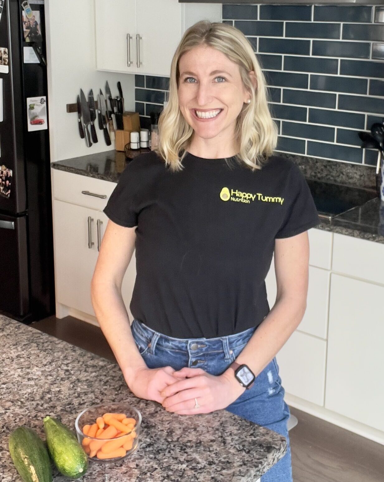 Dietitian in kitchen with zucchini and carrots